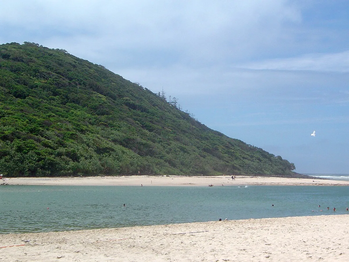 Wooded Burleigh headland across the water at Tallebudgera Creek